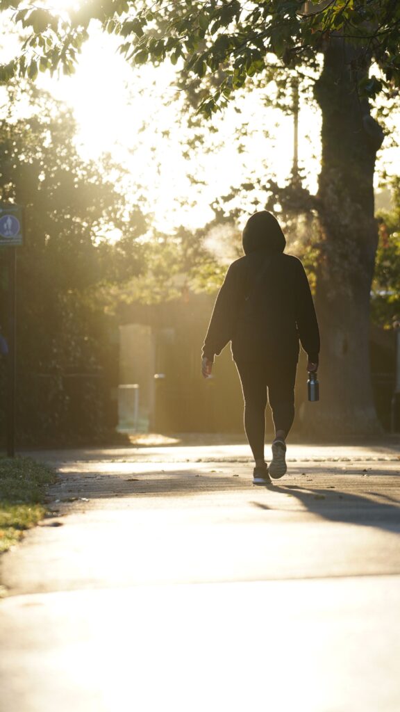 A woman walking alone around dusk